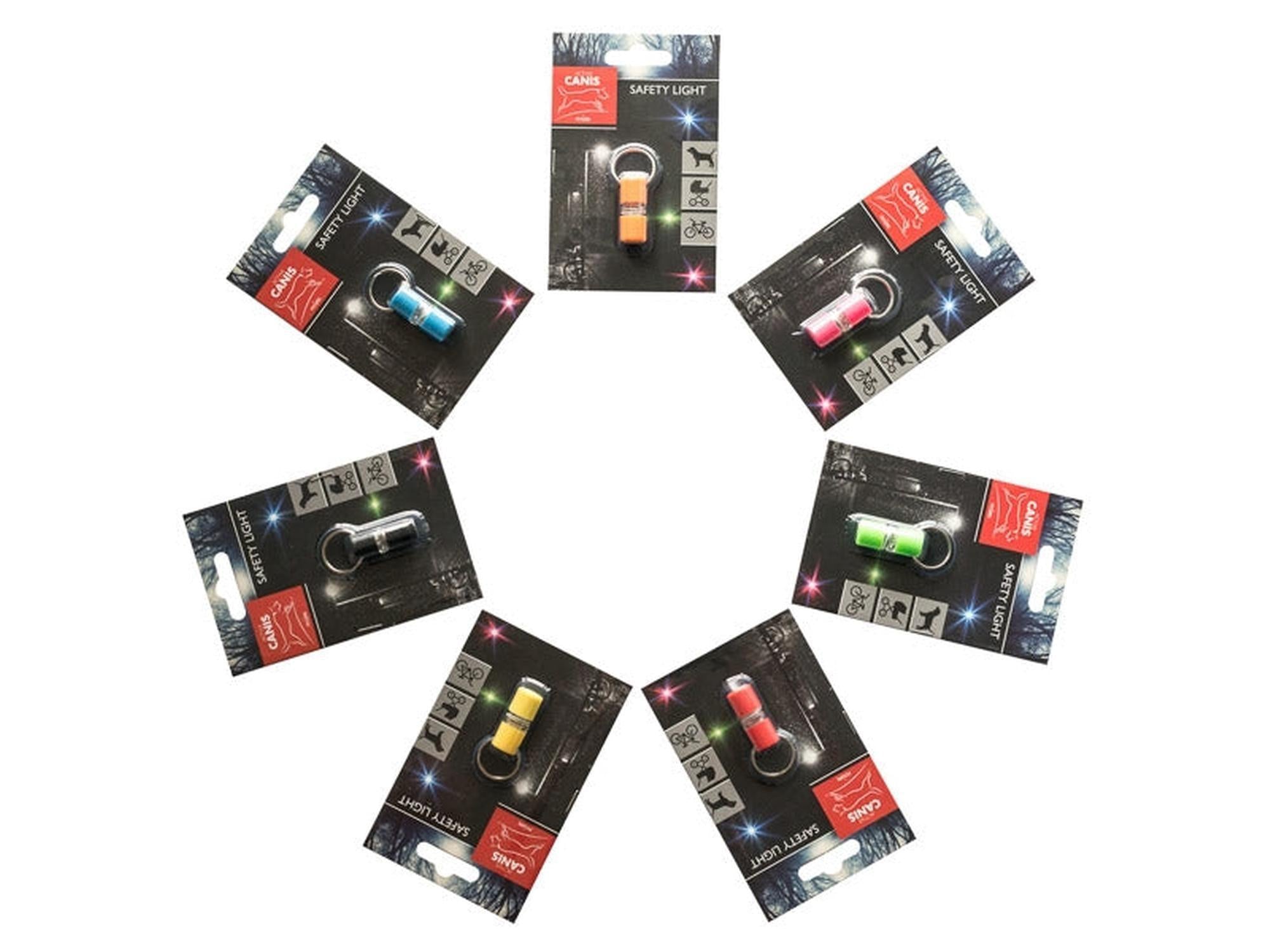 Seks Active Canis Mini LED sikkerhetslys i ulike farger (blå, rosa, grønn, gul, rød, svart) på emballasje.