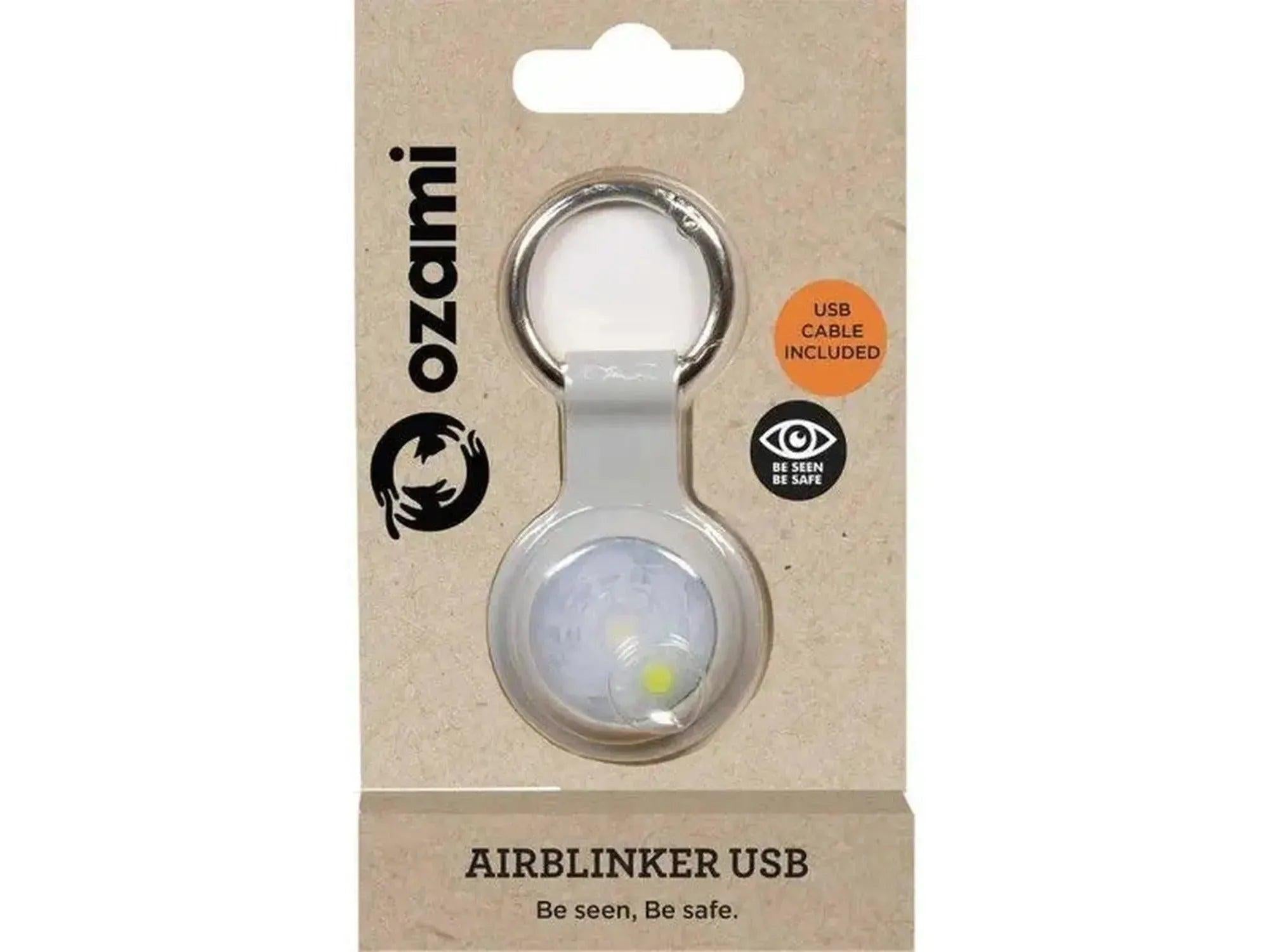 Grå Airblinker LED-lykt i silikon med metallring, pakket på brun kartong.