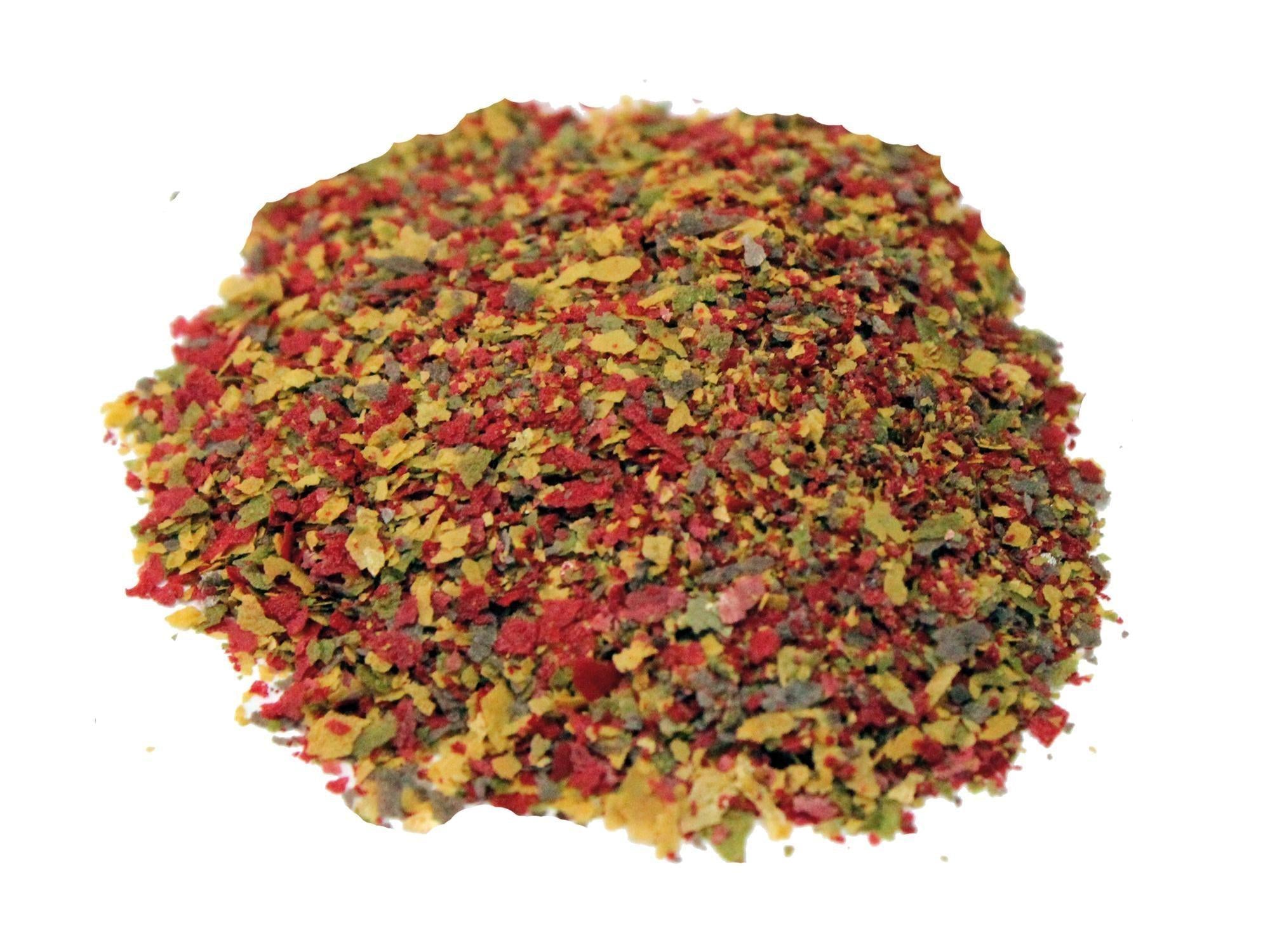 Pile of colorful micro-sized baby fish flakes in red, yellow, and green.