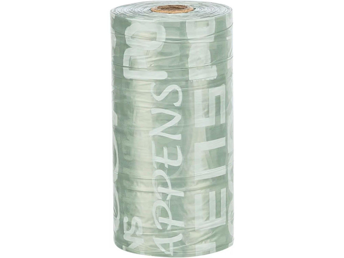 Rull med grønne, luktfrie hundeposer med hvit tekst, perfekt for dispenser.